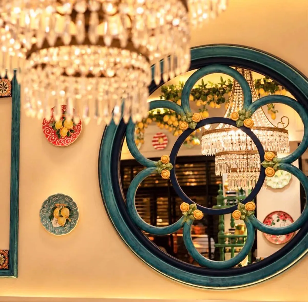 A crystal chandelier and the flower-framed mirror