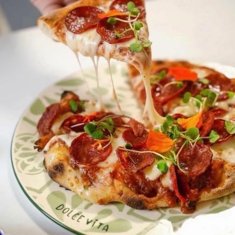 Pizza with salami and micro herbs