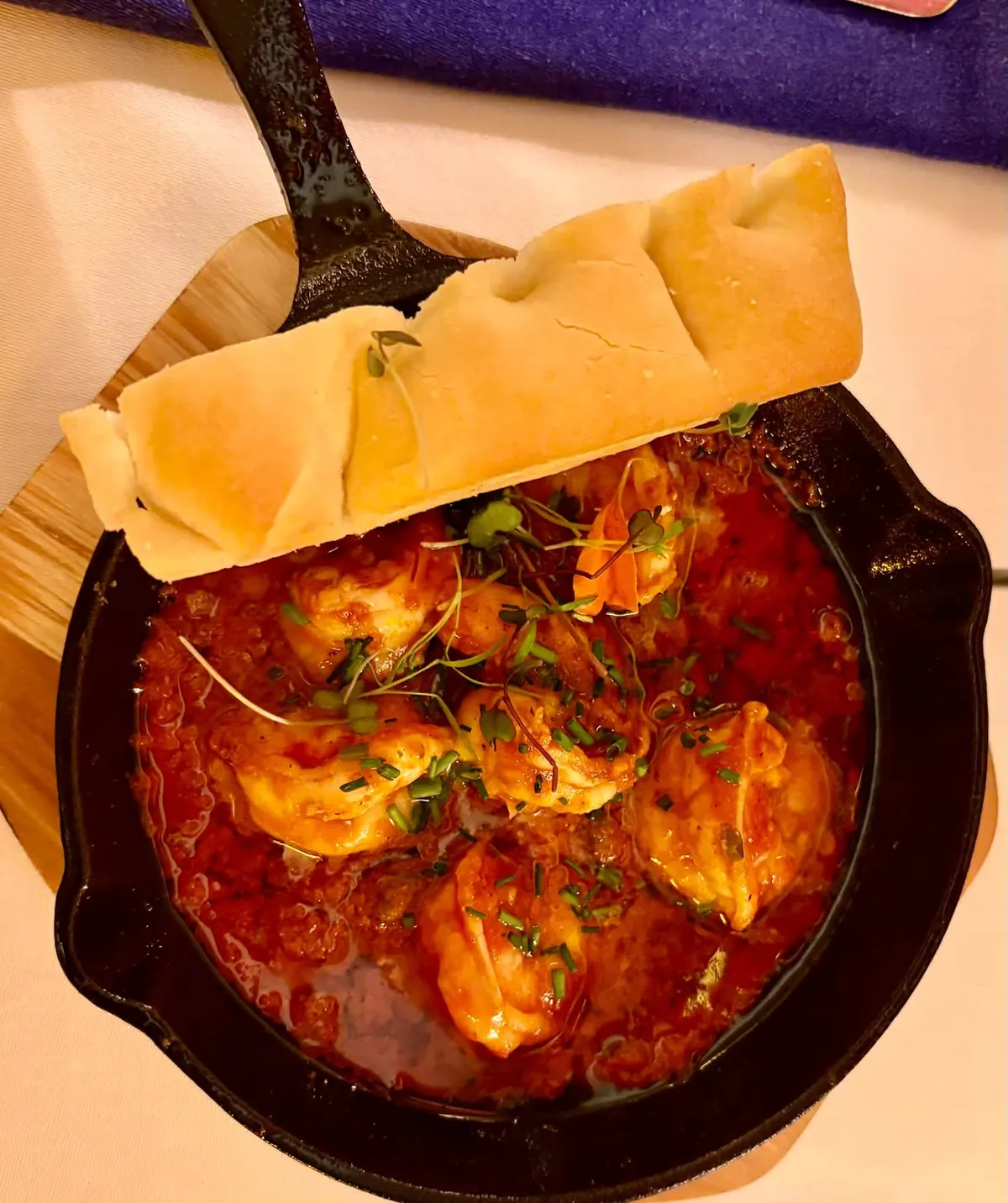 Prawns in tomato sauce, served in the skillet with bread