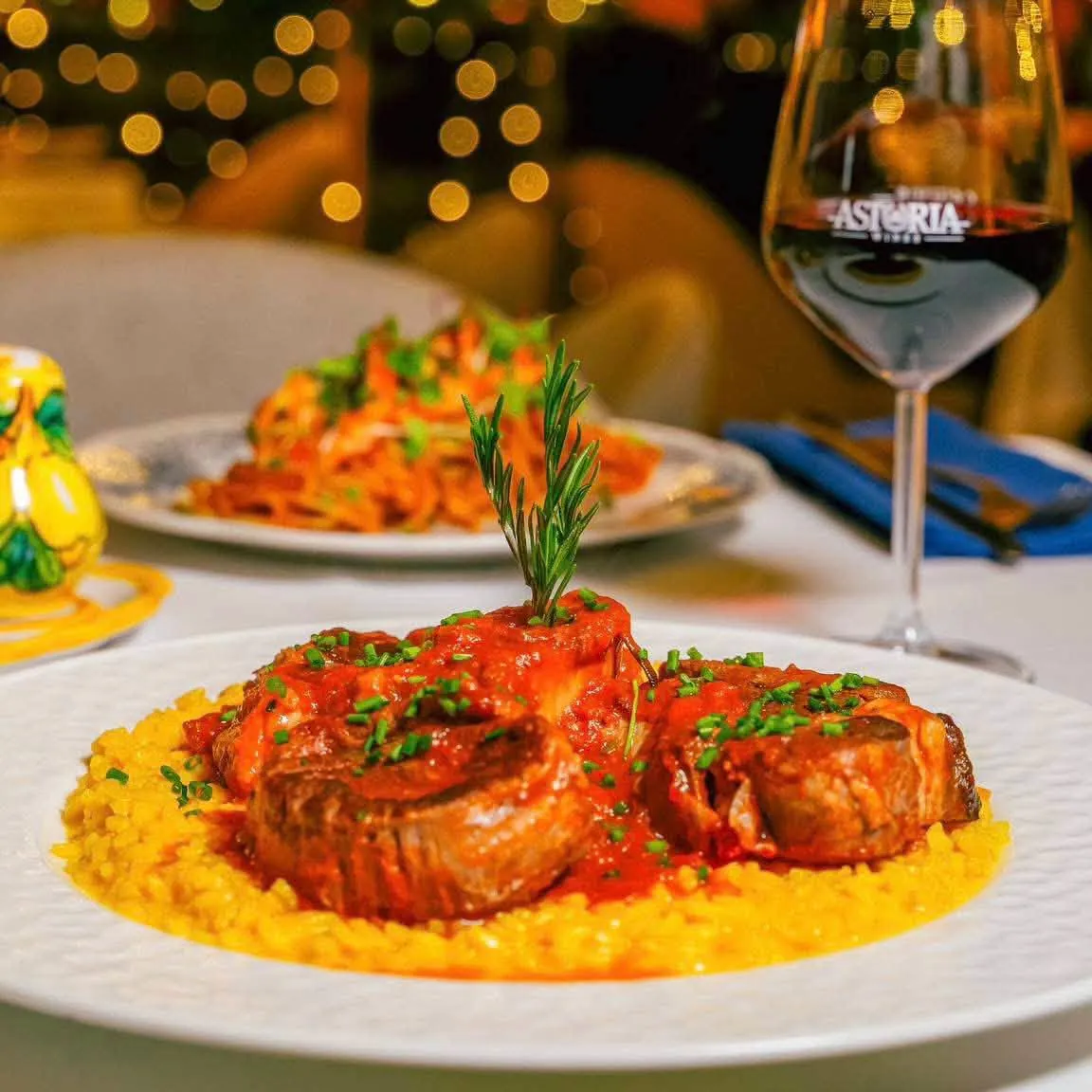 Meat in tomato sauce over golden risotto