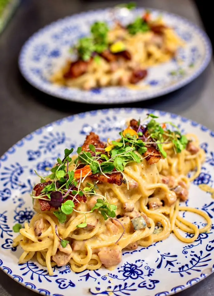 Creamy spaghetti on blue-and-white plates