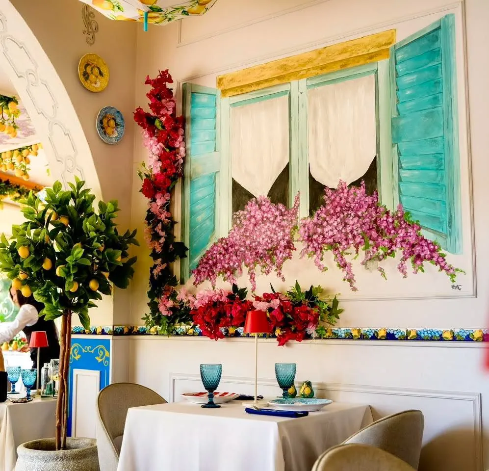 The painted window wall with turquoise shutters and bougainvillea